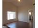 View of living room featuring tile flooring, ample sunlight, and arched entry to the kitchen at 1044 N Abner --, Mesa, AZ 85205