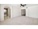 Spacious main bedroom with carpet, a ceiling fan, and access to a bathroom and hallway at 1044 N Abner --, Mesa, AZ 85205
