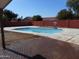 Backyard pool featuring a basketball hoop and a brick paved deck at 1044 N Abner --, Mesa, AZ 85205