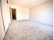 A bright bedroom features neutral walls and carpet with an open door to another room at 10828 N Biltmore Dr # 133, Phoenix, AZ 85029