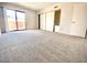 A bright bedroom features neutral walls and carpet with sliding glass doors to a patio at 10828 N Biltmore Dr # 133, Phoenix, AZ 85029