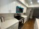 Modern kitchen featuring white cabinets, stainless steel appliances, and marble countertops at 10828 N Biltmore Dr # 133, Phoenix, AZ 85029