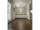 Bright living room with hardwood floors, white cabinets, and a decorative light fixture at 10828 N Biltmore Dr # 133, Phoenix, AZ 85029