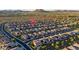 Aerial view of homes with solar panels in a desert community with mountain views at 13330 W Milton Dr, Peoria, AZ 85383