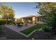 Spacious backyard with a paver patio, seating, artificial turf, and desert landscaping at 13330 W Milton Dr, Peoria, AZ 85383