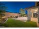Spacious backyard featuring a brick paver patio with lawn and shrubbery at 13330 W Milton Dr, Peoria, AZ 85383
