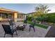 Inviting backyard area with a paver patio, firepit, seating, and manicured landscaping at 13330 W Milton Dr, Peoria, AZ 85383