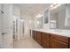 The bathroom features double sinks, wood cabinets, and a glass door shower at 13330 W Milton Dr, Peoria, AZ 85383