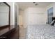 This bedroom features wood floors, plantation shutters, and access to an ensuite at 13330 W Milton Dr, Peoria, AZ 85383
