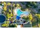 Birds eye view of the community pool with canopies, lounge chairs, and lush trees at 13330 W Milton Dr, Peoria, AZ 85383