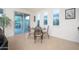 Cozy dining area with a glass table and chairs, next to a sliding glass door and windows at 13330 W Milton Dr, Peoria, AZ 85383
