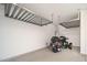 Spacious garage with epoxy flooring and installed overhead storage racks, motorcycle at 13330 W Milton Dr, Peoria, AZ 85383