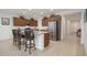 Well-lit open kitchen with a stainless steel refrigerator and granite countertops at 13330 W Milton Dr, Peoria, AZ 85383