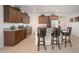 Modern kitchen with stainless steel appliances, granite countertops, and a breakfast bar with seating at 13330 W Milton Dr, Peoria, AZ 85383