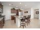 Spacious kitchen with a granite island, seating, stainless steel refrigerator and wooden cabinets at 13330 W Milton Dr, Peoria, AZ 85383