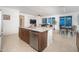Kitchen island featuring stainless steel dishwasher and sink, plus granite countertop and seating at 13330 W Milton Dr, Peoria, AZ 85383