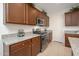 Close-up of a modern kitchen with granite countertops, stainless steel appliances, and wooden cabinets at 13330 W Milton Dr, Peoria, AZ 85383