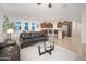 Spacious living room that opens up to the kitchen, featuring tile flooring and natural light at 13330 W Milton Dr, Peoria, AZ 85383