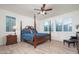 Inviting main bedroom with a four-poster bed, light hardwood floors, and plenty of natural light at 13330 W Milton Dr, Peoria, AZ 85383