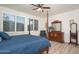 The main bedroom features wood floors, plantation shutters, and a decorative dresser at 13330 W Milton Dr, Peoria, AZ 85383