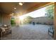 Relaxing covered patio with ceiling fans, comfortable seating, and brick pavers at 13330 W Milton Dr, Peoria, AZ 85383