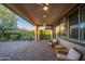 Cozy covered patio with seating, ceiling fans, and a view of the lush backyard at 13330 W Milton Dr, Peoria, AZ 85383