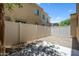 Private backyard with gravel, concrete patio, and white fence in a residential neighborhood at 1367 S Country Club Dr # 1221, Mesa, AZ 85210