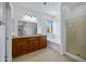 Bright bathroom with dual sinks, granite countertops, a bathtub, and a glass-enclosed shower at 1367 S Country Club Dr # 1221, Mesa, AZ 85210