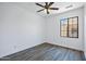 Bright bedroom with wood-look floors, a ceiling fan, and a window with a view at 1367 S Country Club Dr # 1221, Mesa, AZ 85210