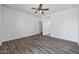 Bedroom featuring a ceiling fan, wood-look floors, and archway to another room at 1367 S Country Club Dr # 1221, Mesa, AZ 85210