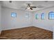Bright and airy bonus room with wood-look floors, a ceiling fan, and lots of windows at 1367 S Country Club Dr # 1221, Mesa, AZ 85210