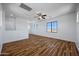 Open concept bonus room featuring wood-look floors, multiple windows, and a ceiling fan at 1367 S Country Club Dr # 1221, Mesa, AZ 85210