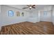 Bright bonus room with wood-look floors, unique arched windows, and a ceiling fan at 1367 S Country Club Dr # 1221, Mesa, AZ 85210
