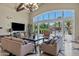 Bright clubhouse lounge area features a wall of windows and doors to a pool area and lush landscaping at 1367 S Country Club Dr # 1221, Mesa, AZ 85210