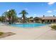 Large community pool with clear blue water, surrounded by palm trees and comfortable lounge chairs for residents to enjoy at 1367 S Country Club Dr # 1221, Mesa, AZ 85210