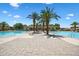 Expansive community pool with palm trees, lounge chairs, and a paved walkway, perfect for exercise and outdoor gatherings at 1367 S Country Club Dr # 1221, Mesa, AZ 85210
