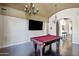Spacious game room featuring a pool table, dark wood floors, elegant lighting, and a large screen television at 1367 S Country Club Dr # 1221, Mesa, AZ 85210