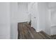 Bright hallway featuring wood-look floors, white walls, and access to staircase at 1367 S Country Club Dr # 1221, Mesa, AZ 85210