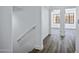 Bright hallway featuring wood-look floors, white walls, and access to bedrooms with well-lit windows at 1367 S Country Club Dr # 1221, Mesa, AZ 85210