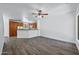 Inviting living space featuring wood-look floors, a kitchen area, and bright white walls at 1367 S Country Club Dr # 1221, Mesa, AZ 85210