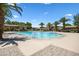 Community swimming pool surrounded by lounge chairs, palm trees, and desert landscaping at 1367 S Country Club Dr # 1221, Mesa, AZ 85210