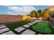 Expansive backyard featuring a putting green, patio area, and lush green space at 14481 W Via Del Oro --, Surprise, AZ 85379