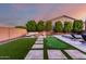 Expansive backyard featuring a putting green, pool, spa, and outdoor seating at 14481 W Via Del Oro --, Surprise, AZ 85379