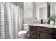 A well-lit bathroom featuring a striped shower curtain and granite countertop at 14481 W Via Del Oro --, Surprise, AZ 85379