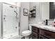 A clean bathroom featuring a glass shower and dark wood cabinets at 14481 W Via Del Oro --, Surprise, AZ 85379
