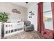 Cozy Bedroom with custom name wall decor, crib, and comfortable seating at 14481 W Via Del Oro --, Surprise, AZ 85379