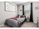 Cozy bedroom decorated with football themed decor, a bed with a grey comforter, and carpet at 14481 W Via Del Oro --, Surprise, AZ 85379