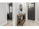 Entryway with stylish console table, decorative mirror, and tile flooring creating a warm welcome at 14481 W Via Del Oro --, Surprise, AZ 85379