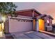 Two-car garage on a charming single-Gathering home featuring a beautiful shingle detail and an American flag at 14481 W Via Del Oro --, Surprise, AZ 85379