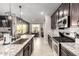 Elegant kitchen with granite countertops, stainless steel appliances, and views into the dining area at 14481 W Via Del Oro --, Surprise, AZ 85379